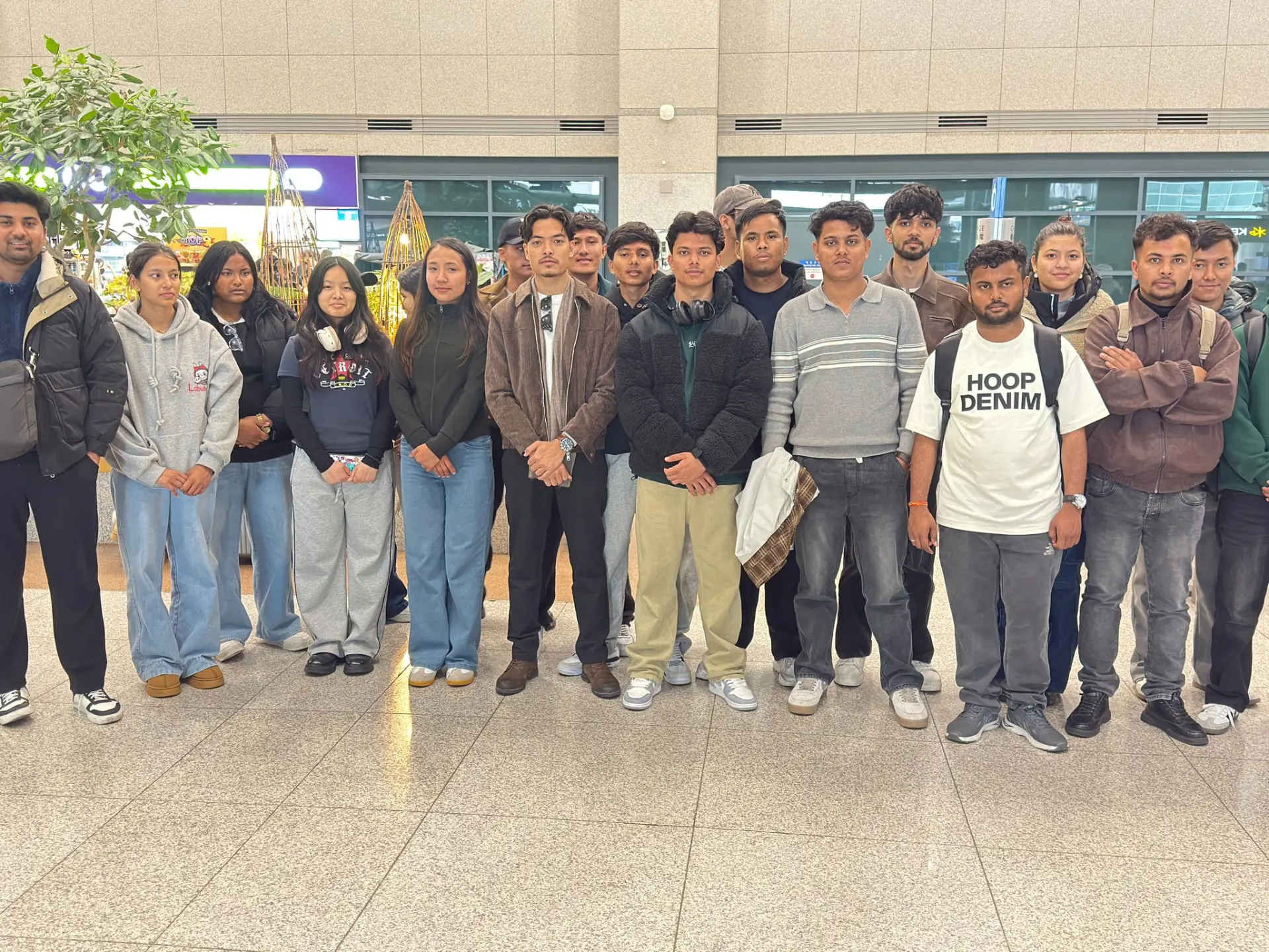 Large group of Khusi students in a Korean airport arrival hall